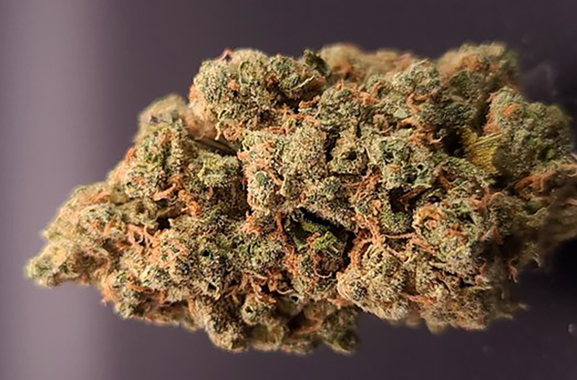 A ball of cannabis flower on a dark background