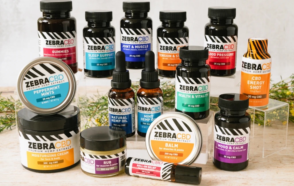 All the different products of Zebra CBD with few leaves in the background