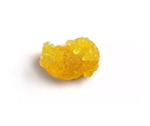 A small portion of CBD wax in a white background