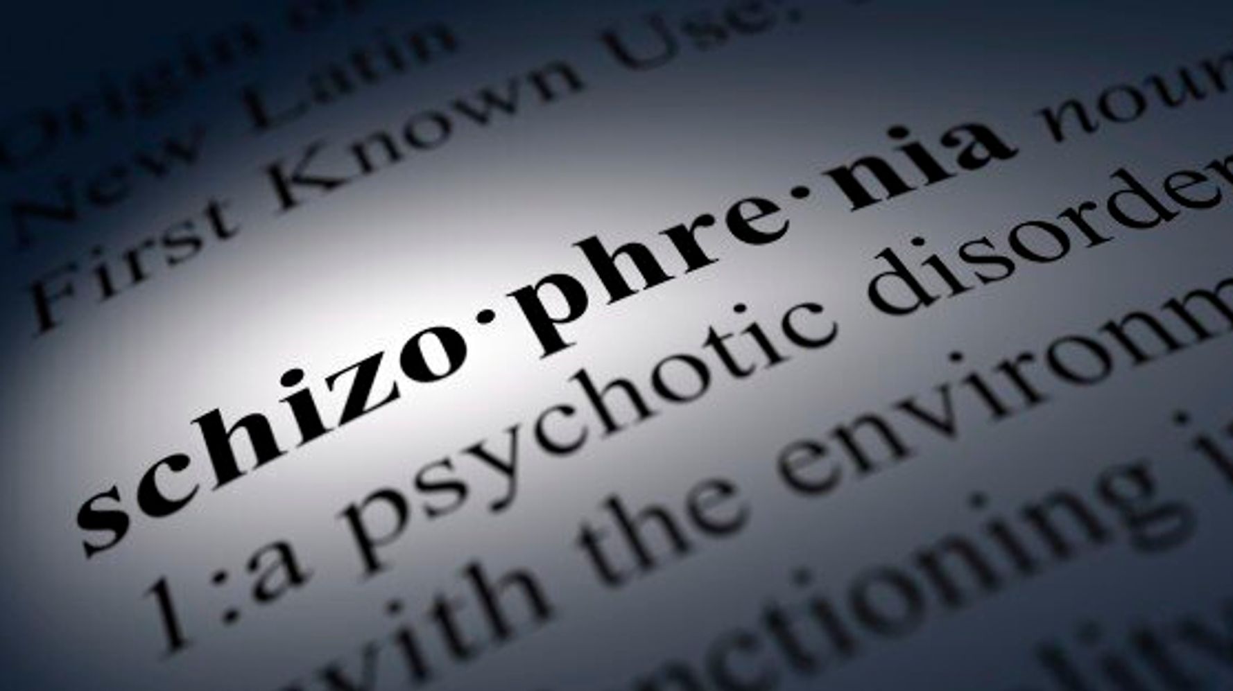 The word schizophrenia written in black on a white note 