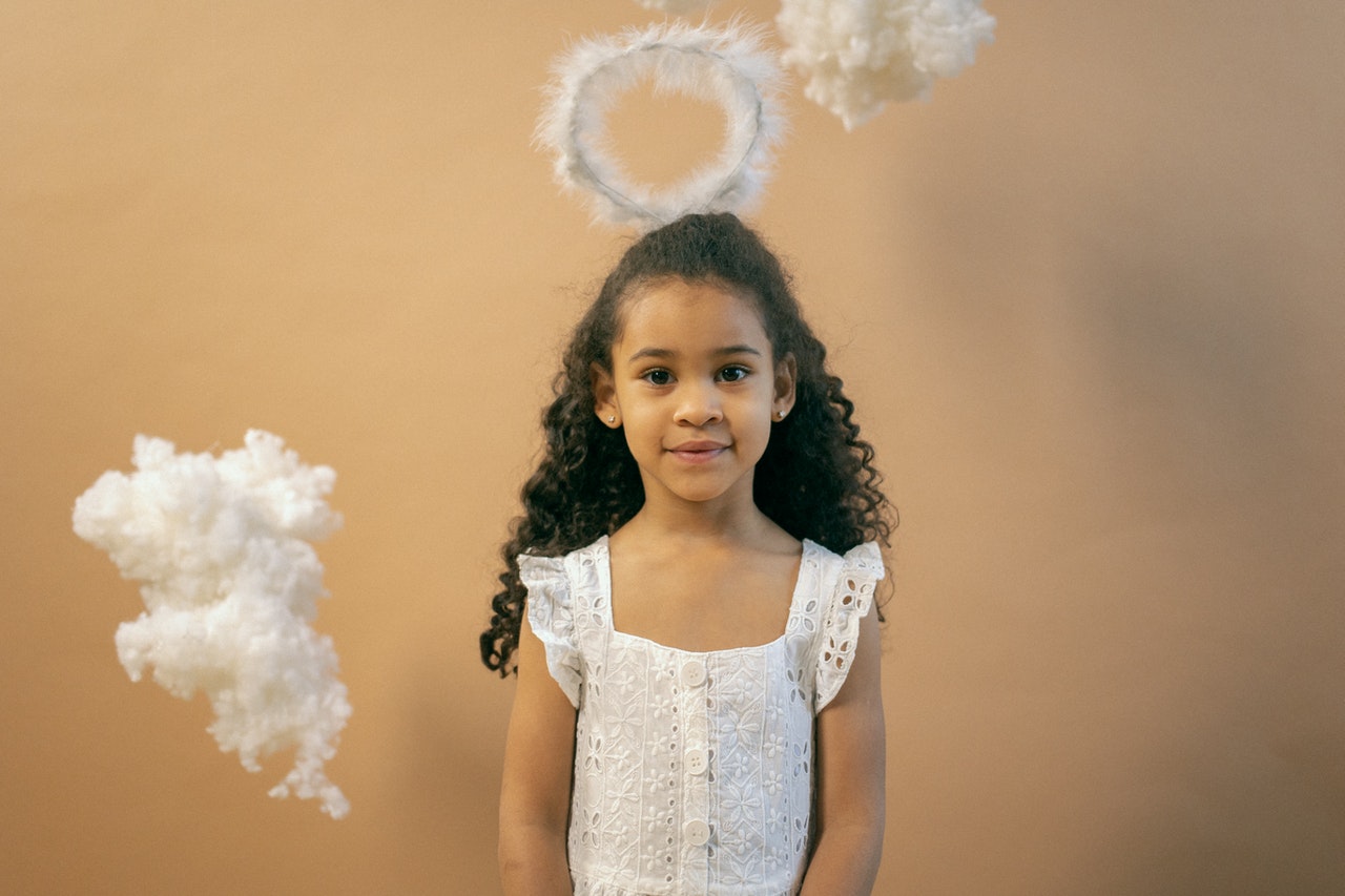 Adorable girl in angel outfit with nimbus