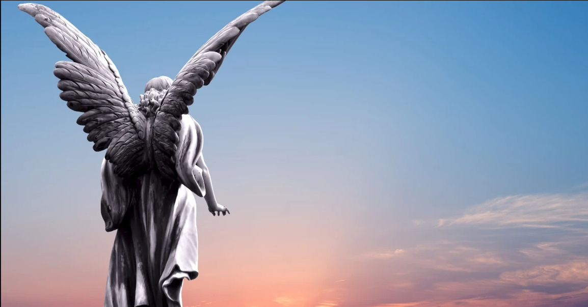 A statue of an angel with open wings in the evening sky